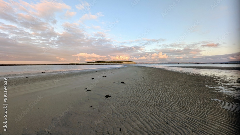 Dramatic coastal sunset landscape scenery with cliffs in background, sandy Silverstrand beach, Galway, Ireland, nature wallpaper