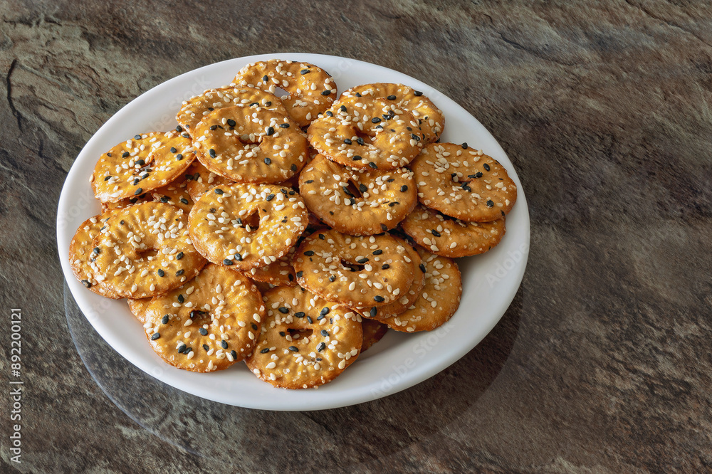Close up of salted round pretzels with black and white sesame Close up of salted round pretzels with black and white sesame