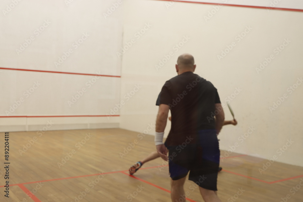 Playing squash in the court Playing squash in the court