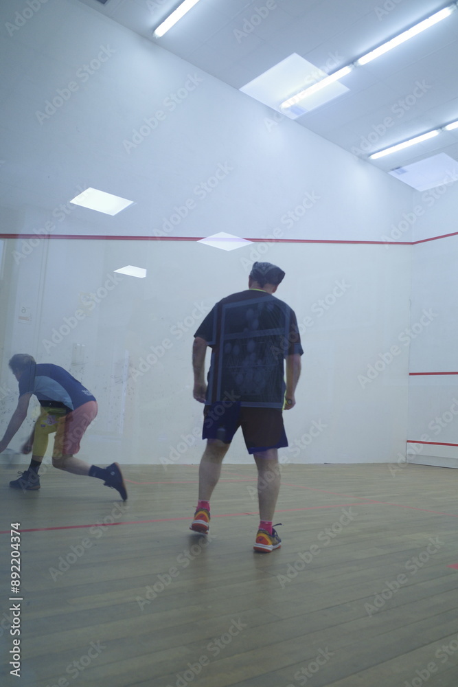 Playing squash in the court Playing squash in the court