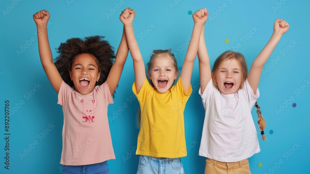 Three little girls are holding their hands up in the air Three little girls are holding their hands up in the air