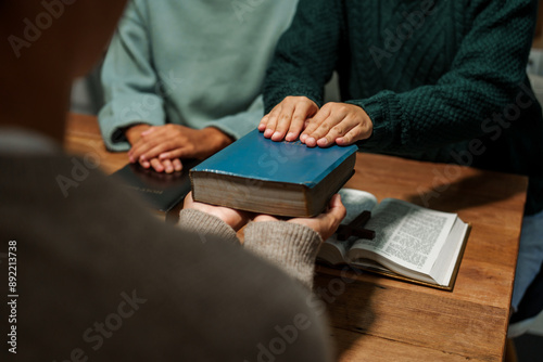 A person reads the Bible, embodying faith and spirituality. The scene reflects a serene moment of contemplation and devotion, highlighting the importance of religion in everyday life.