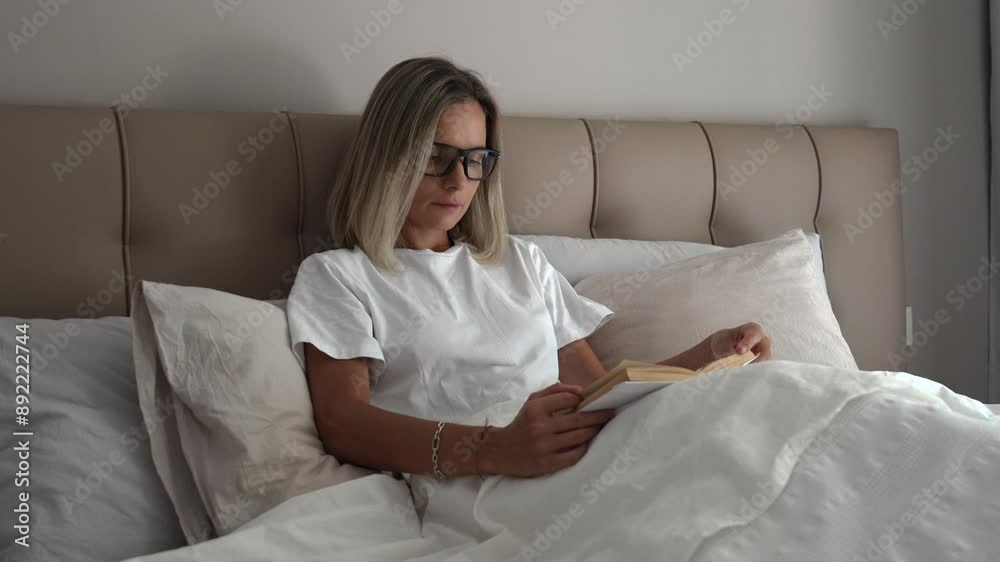 blonde woman reading book on the bed blonde woman reading book on the bed