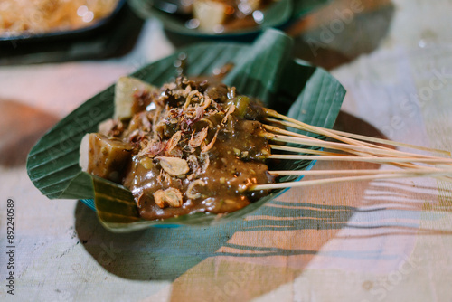 Quadro su tela Padang satay skewers, grilled to perfection and served with a rich, spicy sauce,