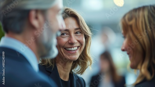 A group of business people mingling at a conference, laughing and having fun working together