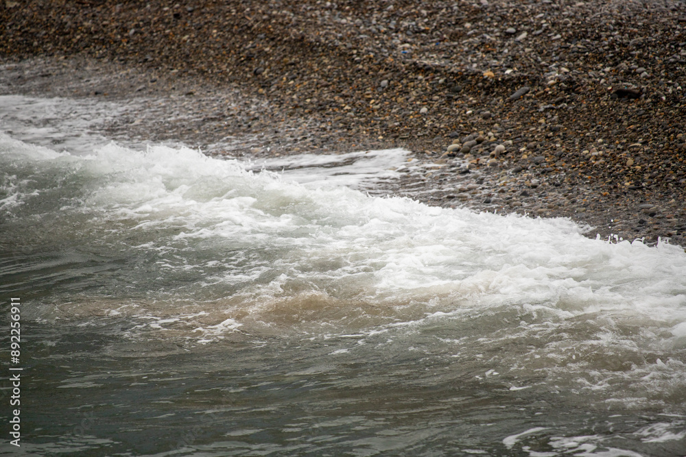 Seashore, small stones, sea wave. Marine background. Seashore, small stones, sea wave. Marine background.