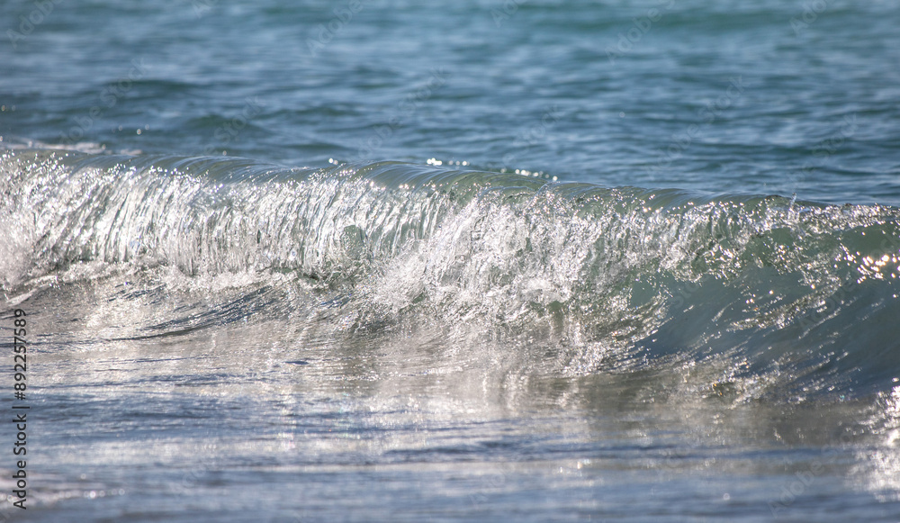 A sea wave breaks against the rocks, water splashes in the sky. Tidal wave. A sea wave breaks against the rocks, water splashes in the sky. Tidal wave.