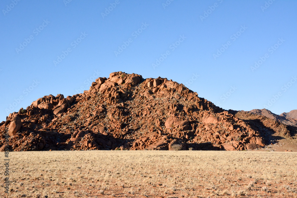 Stone peak on the hill against the background of the blue sky. Tourist destinations and nature Stone peak on the hill against the background of the blue sky. Tourist destinations and nature