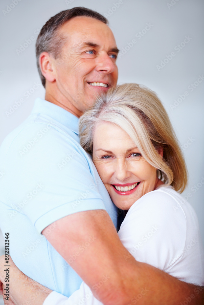 Senior couple, happy and portrait in gray background in love, hug or embrace as romantic partner. Woman, man and affection for bonding, relationship and together in studio backdrop for health or care Senior couple, happy and portrait in gray background in love, hug or embrace as romantic partner. Woman, man and affection for bonding, relationship and together in studio backdrop for health or care