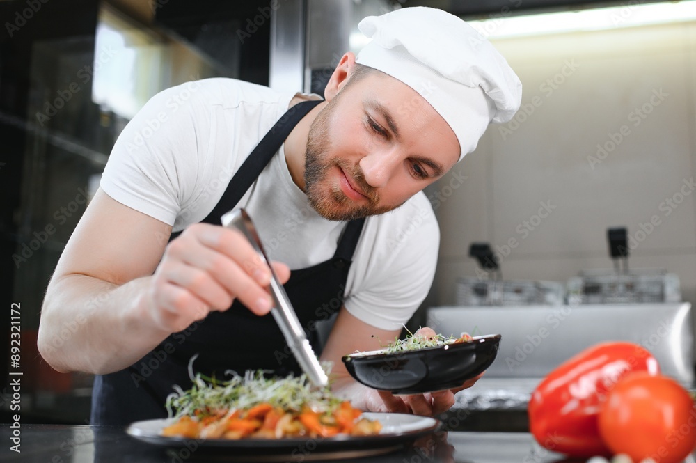 Portrait of handsome positive chef cook at the restaurant kitchen Portrait of handsome positive chef cook at the restaurant kitchen