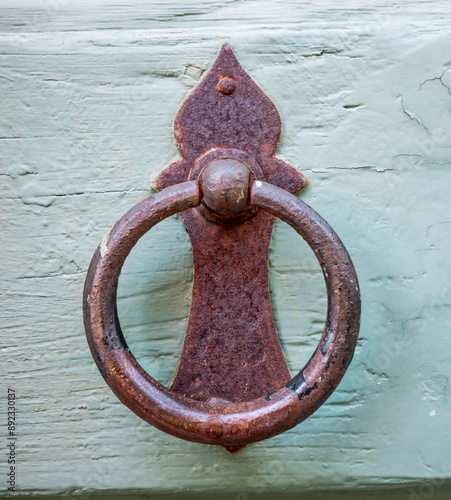 Ancient door knocker dating back to the 19th century. Copyspace around.