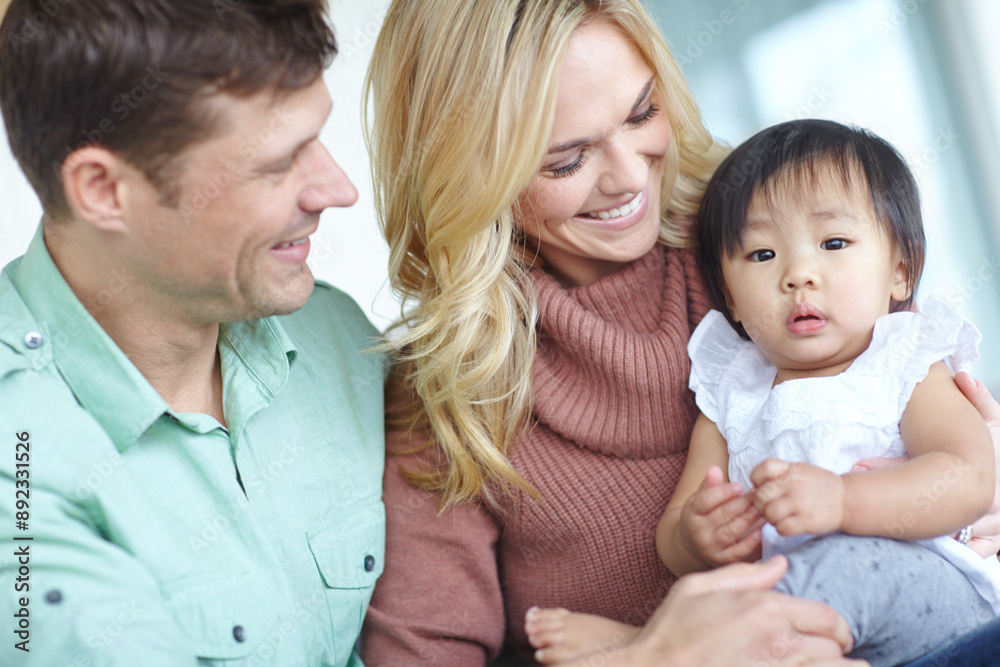 Couple, adoption and asian child for family in home, love or girl for foster care. Together, bonding or support with married man and female person, diversity and baby for trust and hug in living room Couple, adoption and asian child for family in home, love or girl for foster care. Together, bonding or support with married man and female person, diversity and baby for trust and hug in living room