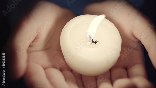 Portrait of the girl with a candle in hands. The spirituality face . Mood of sacrament and revelation