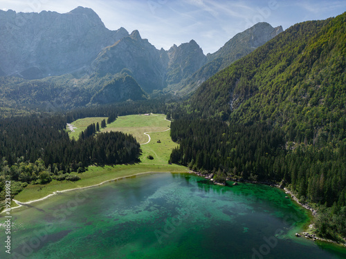 Drone shot flying. Lago Inferiore di Fusine Lake in Italy. Boat. photo