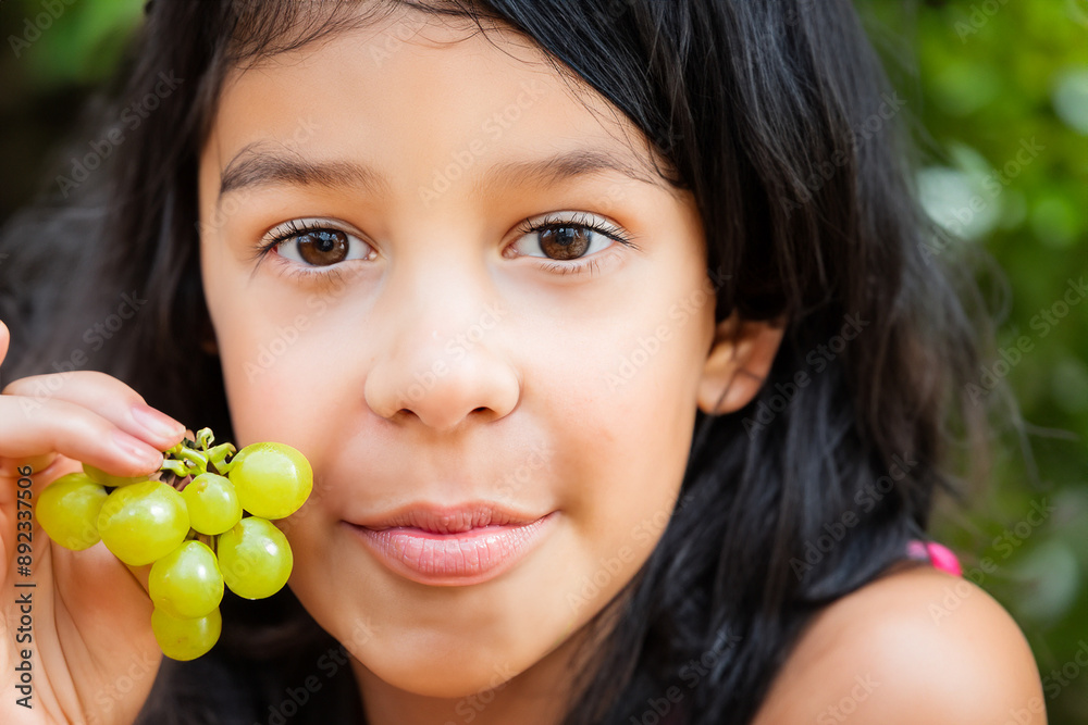 Girl eating grapes for healthy snack. cheese board fruit concept. a girl is eating a bunch of grapes. a girl eating a bunch of grapes for health lifestyle. Girl eating grapes for healthy snack. cheese board fruit concept. a girl is eating a bunch of grapes. a girl eating a bunch of grapes for health lifestyle.