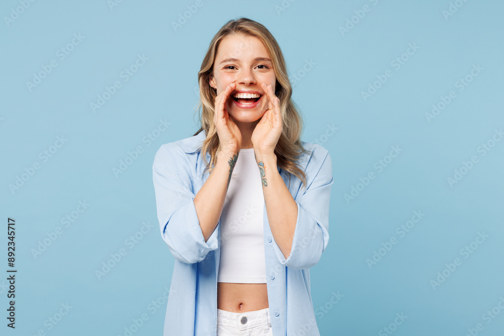 Young woman she wears white top shirt casual clothes scream sharing hot news about sales discount with hands near mouth isolated on plain pastel light blue cyan background studio. Lifestyle concept. Young woman she wears white top shirt casual clothes scream sharing hot news about sales discount with hands near mouth isolated on plain pastel light blue cyan background studio. Lifestyle concept.