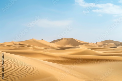 Vast desert landscape with rolling sand dunes under a clear blue sky.