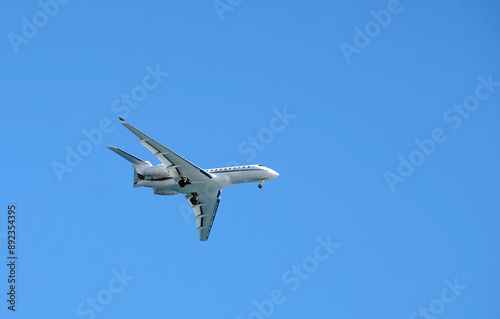 Private jet against the blue sky as it approaches Nice, France