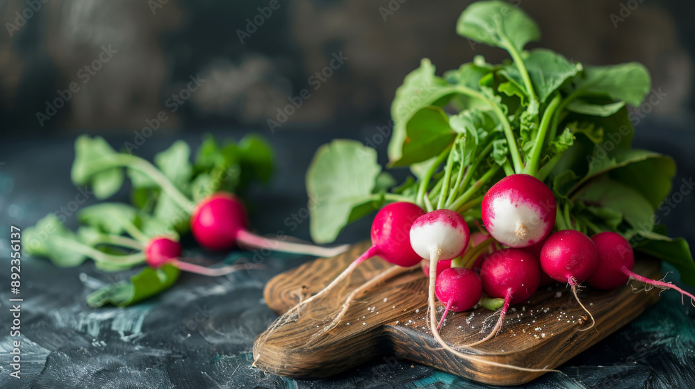 A bunch of radishes on a wooden board. dark background A bunch of radishes on a wooden board. dark background