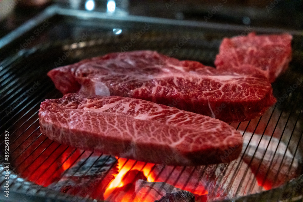Hanwoo Beef, Korean Style Meat on the Grill. BBQ rare meat with soft focus Hanwoo Beef, Korean Style Meat on the Grill. BBQ rare meat with soft focus