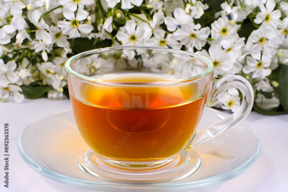 A mug of hot drinks with flowers. Top view cup concept. White mug with flowers for tea. A woman drinking tea in a mug with white lifestyle flowers. A mug of hot drinks with flowers. Top view cup concept. White mug with flowers for tea. A woman drinking tea in a mug with white lifestyle flowers.