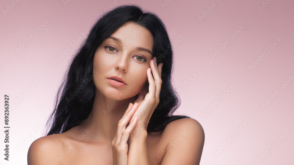 Elegant Woman with Long Dark Hair Posing Against Pink Background Elegant Woman with Long Dark Hair Posing Against Pink Background