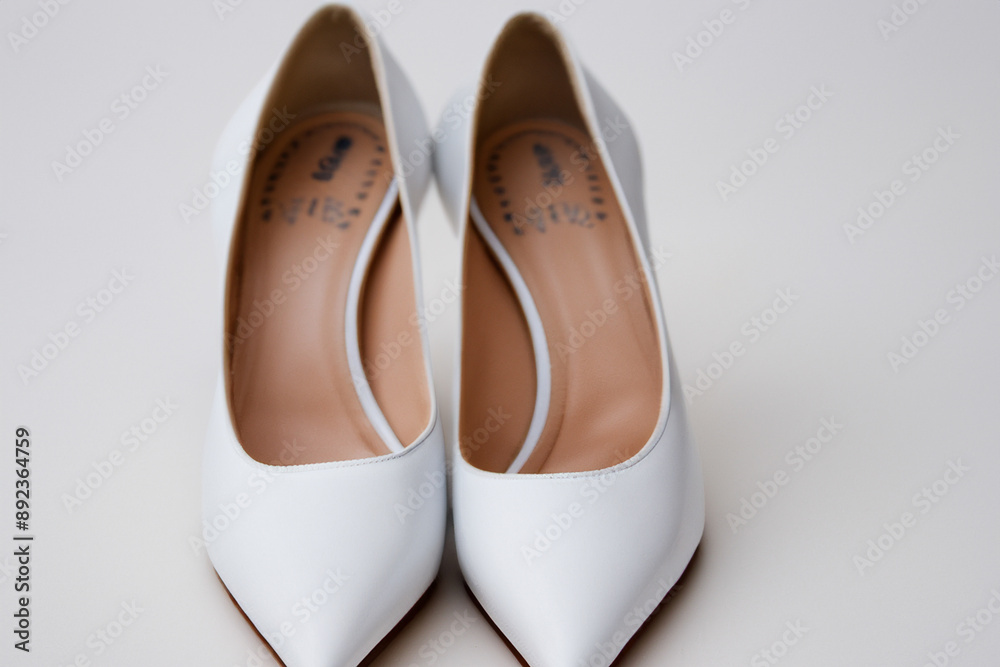 Fototapeta premium Beautiful women a white dress with shoes ations. fashion woman luxury concept. a woman in white and a man in heels with bows and shoes. women in bows and heels in a bows and shoes ation lifestyle.