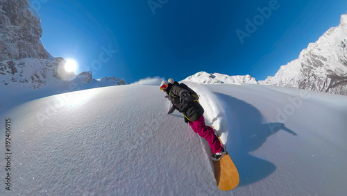 SELFIE, LENS FLARE: Joyful snowboarding of a smiling woman in fresh powder snow photo