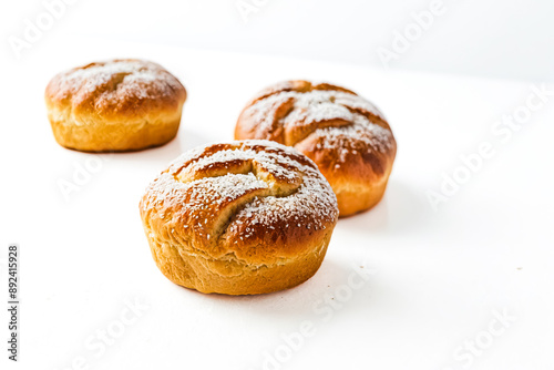 Close-up of freshly baked sweet rolls with sugar and coconut flakes