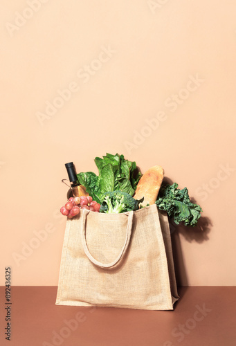 Eco bag filled with grocery and vegetables, sustainable lifestyle concept,  front view, copy space fpr a text