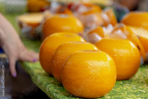 Round ball Edam cheese on market stall, Edammer kaas with a pale yellow or paraffin wax, Edam is a semi-hard cheese that originated in the Netherlands, It is one of the most popular cheeses worldwide. photo