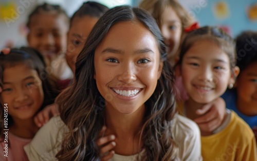 Smiling Teacher Poses With Young Students In Classroom