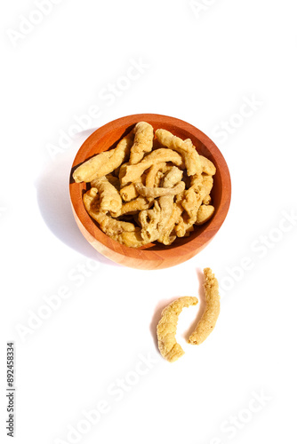 Fried chicken intestines Indonesian food is called usus goreng in a small wooden bowl isolated on white background photo