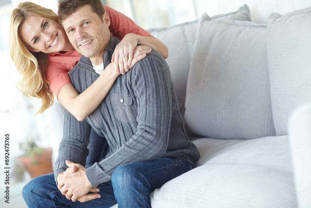 Portrait, hug and happy couple in home for relax, love and loyalty together in lounge. Smile, man and woman embrace on sofa for support, connection and care for relationship commitment with partner Portrait, hug and happy couple in home for relax, love and loyalty together in lounge. Smile, man and woman embrace on sofa for support, connection and care for relationship commitment with partner