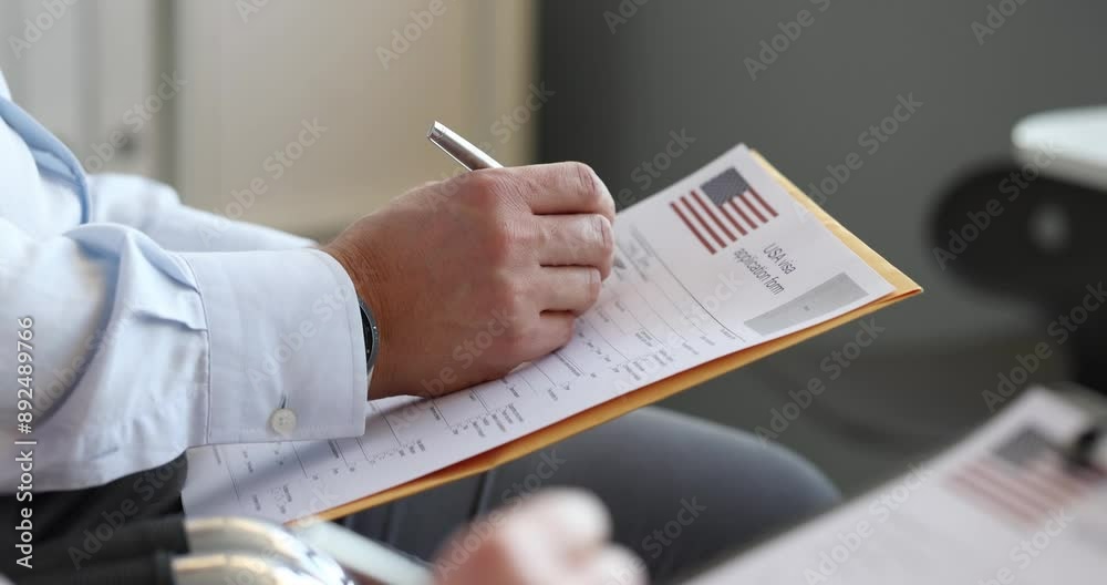 Man fills out USA visa application form. Getting green card usa concept