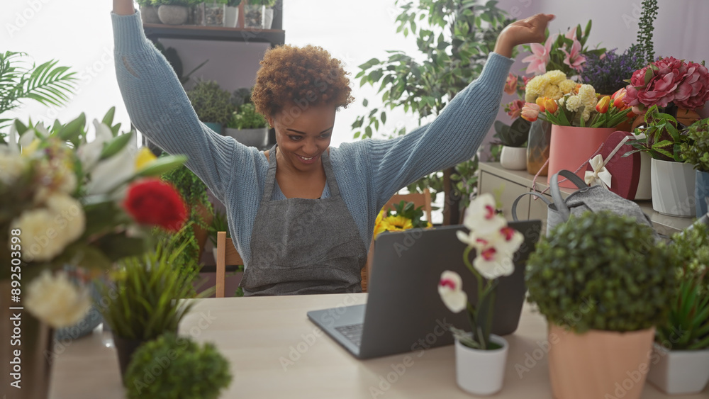 An african american woman enjoying her time as a florist in a vibrant flower shop, surrounded by diverse plants.
