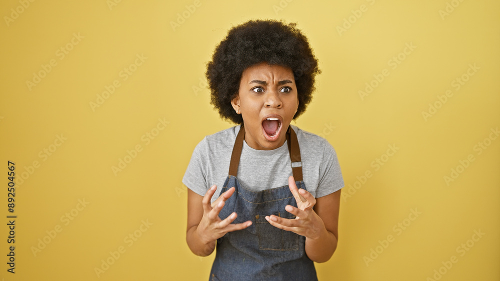 A surprised african woman with curly hair stands against a yellow background, expressing astonishment. A surprised african woman with curly hair stands against a yellow background, expressing astonishment.