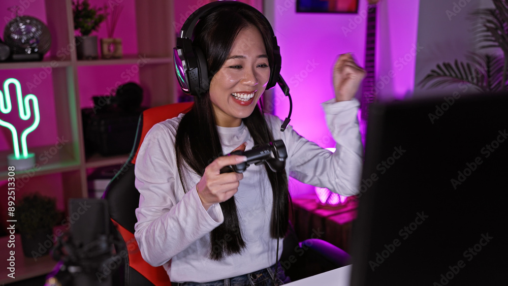 Happy asian woman enjoying gaming in a neon-lit room at night. Happy asian woman enjoying gaming in a neon-lit room at night.