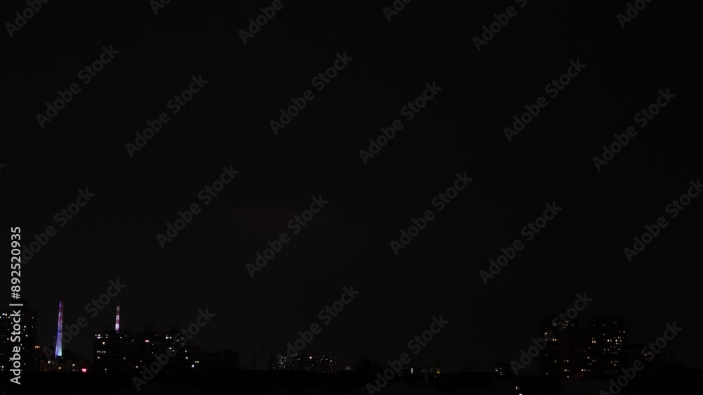 Lightning flashes through dark storm clouds in city. Black clouds before the thunderstorm. 4k slow motion footage, loop able b roll video.