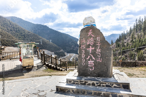 Viewing platform of China G318 national highway. The sign post is embedded in Chinese language translated into English as National Highway 18 Bends, Altitude 3990m above sea level. photo