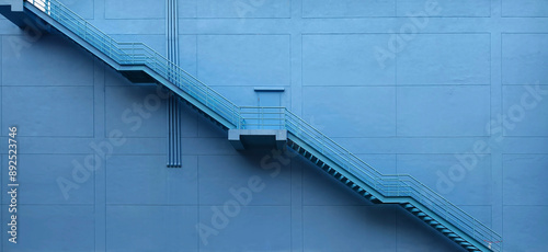 Fotografie A set of stairs ascending a large blue wall