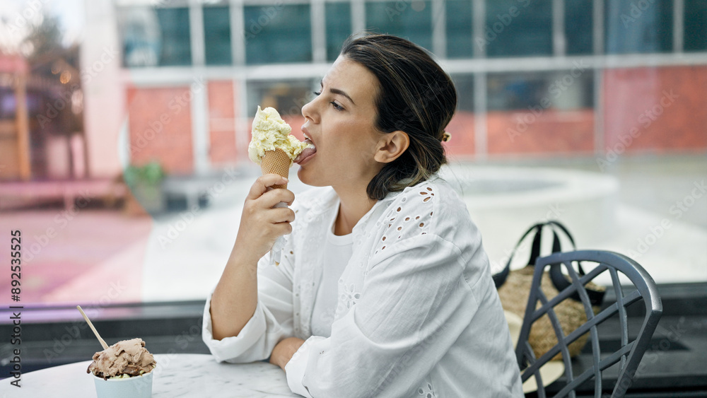 Beautiful young hispanic woman eating ice cream at cafeteria Beautiful young hispanic woman eating ice cream at cafeteria