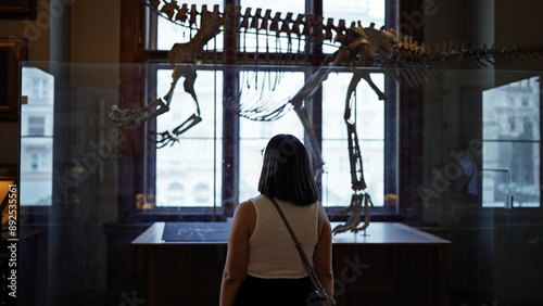 Young beautiful hispanic woman visiting paleontology exhibition at Natural History Museum in Vienna photo