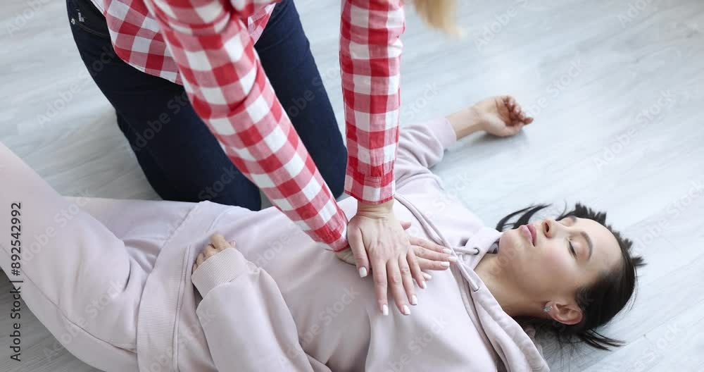 Person checks pulse and makes heart massage to lying woman. Loss of consciousness and heart attack concept