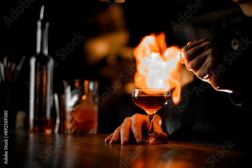 Controlled Inferno. Intense bartender expertly crafts a dangerously fiery libation.