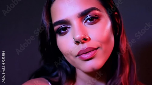 Portrait of a young woman looking in a very sassy way into the camera.