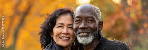 Joyful Embrace of an Elderly Couple in Autumn - This beautiful image captures a joyful elderly couple sharing a warm smile amidst the vibrant autumn foliage, symbolizing love, togetherness, happiness,
