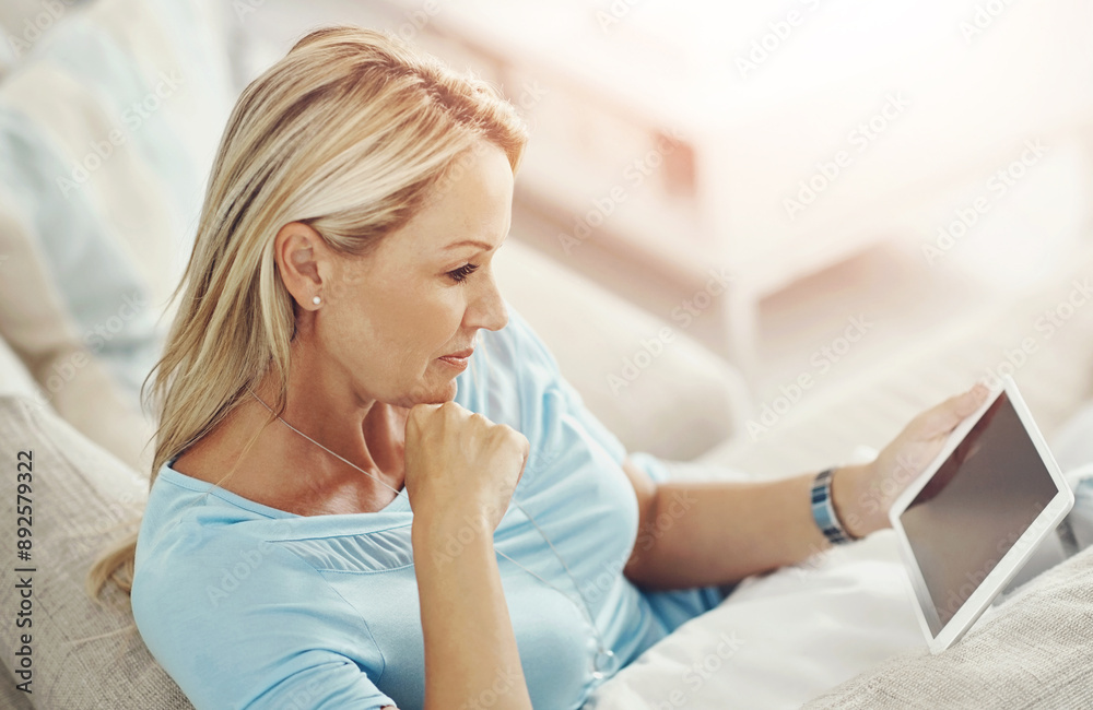 Woman, tablet and reading on sofa in house with mock up space on screen with app, streaming or ebook in lounge. Mature person, digital touchscreen and relax on couch with movie, film or subscription Woman, tablet and reading on sofa in house with mock up space on screen with app, streaming or ebook in lounge. Mature person, digital touchscreen and relax on couch with movie, film or subscription