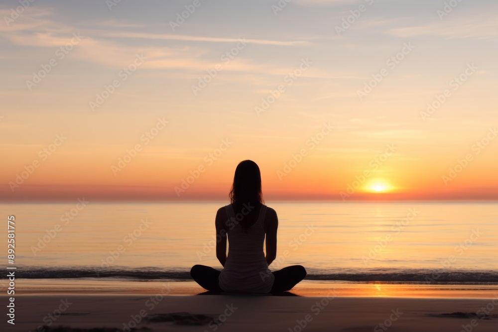 Young woman meditating on a beach at sunrise with copy space Isolated on white background Young woman meditating on a beach at sunrise with copy space Isolated on white background