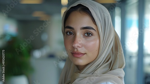 Professional mid-aged hijab woman, clean call center setting, presenting data on a screen to colleagues, wide-angle shot, still life photo.